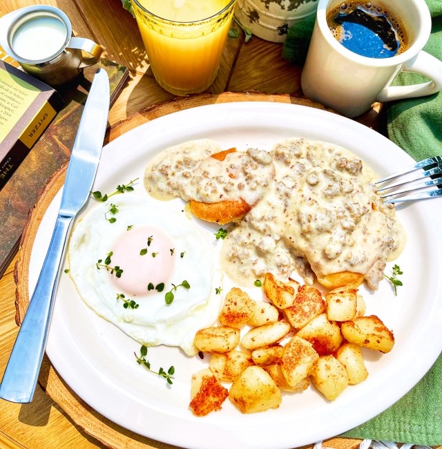 Biscuits and gravy over homemade biscuits, side of egg and potatoes - weekend only