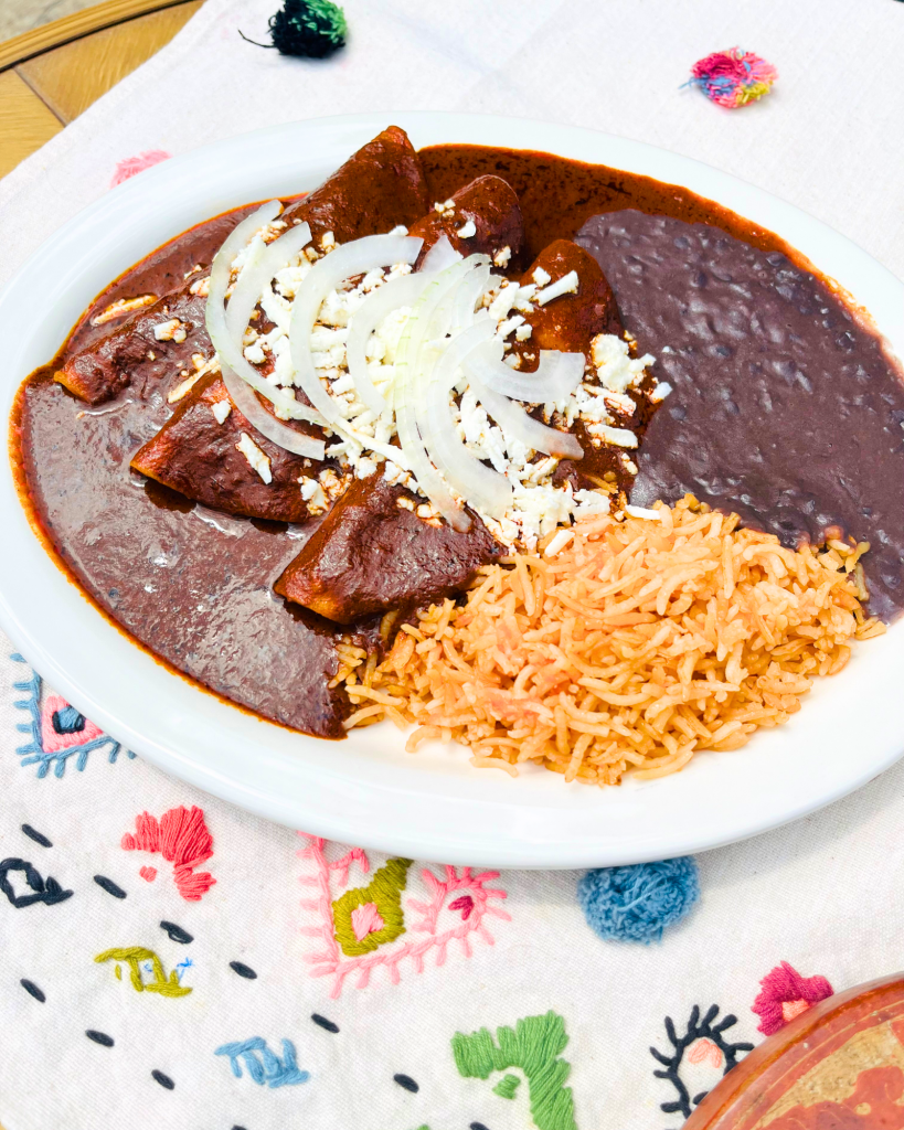 Enchiladas de Mole, Daily Special, chicken filled enchiladas, mexican cheese, queso fresco, rice and black refried beans